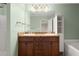 Bathroom with a double vanity, white cabinets and modern lighting at 212 Ranier Court, Canton, GA 30114
