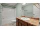 Well-lit bathroom features a shower-tub, toilet, vanity, and framed mirror at 212 Ranier Court, Canton, GA 30114