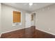 Bedroom with hardwood flooring, a window with blinds, and neutral colored walls at 212 Ranier Court, Canton, GA 30114