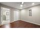 Spacious bedroom boasts an ensuite bathroom and rich hardwood flooring at 212 Ranier Court, Canton, GA 30114