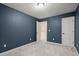 Nicely carpeted bedroom featuring navy-colored walls, and an open doorway at 212 Ranier Court, Canton, GA 30114