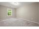 Bright bedroom with neutral walls and plush gray carpet, illuminated by natural light at 212 Ranier Court, Canton, GA 30114