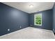 Bedroom with blue walls, a window and neutral carpet at 212 Ranier Court, Canton, GA 30114