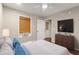 Bedroom featuring a ceiling fan, large television, and neutral tones at 212 Ranier Court, Canton, GA 30114
