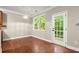 Bright dining area features hardwood floors, door to deck, and modern lighting at 212 Ranier Court, Canton, GA 30114