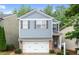 Charming two-story home featuring a brick-accented garage and a well-manicured front yard at 212 Ranier Court, Canton, GA 30114
