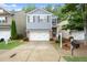 Beautiful home featuring a well-kept lawn, a driveway, and a cozy brick-accented entrance at 212 Ranier Court, Canton, GA 30114