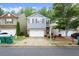 Welcoming home with a tidy yard, double garage, and a classic brick and siding facade at 212 Ranier Court, Canton, GA 30114