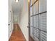 Bright hallway with hardwood floors, white trim, doors, and a window at the end at 212 Ranier Court, Canton, GA 30114