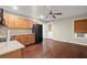 Open-concept kitchen features wood cabinets, stainless steel appliances, and dark hardwood flooring at 212 Ranier Court, Canton, GA 30114