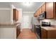 Kitchen with wooden cabinets, stainless steel appliances, and a breakfast bar at 212 Ranier Court, Canton, GA 30114