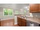 View from kitchen to living room with stainless steel appliances and hardwood floors at 212 Ranier Court, Canton, GA 30114