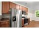 Kitchen featuring stainless steel fridge, and range with wood cabinets at 212 Ranier Court, Canton, GA 30114
