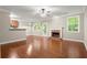 Bright living room with hardwood floors, fireplace, and open concept to the kitchen at 212 Ranier Court, Canton, GA 30114