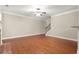 Open living room with hardwood floors, fireplace, and staircase access at 212 Ranier Court, Canton, GA 30114