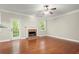 Bright living room features a brick fireplace, hardwood floors, and natural light at 212 Ranier Court, Canton, GA 30114