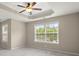 Bright main bedroom with trey ceiling, ceiling fan, and large window at 212 Ranier Court, Canton, GA 30114