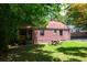 Grassy backyard featuring an outdoor picnic table and lush trees, great for entertainment or relaxing at 3020 Washington Rd, East Point, GA 30344