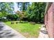 Expansive backyard featuring lush landscaping, picnic table, a fire pit, and mature trees for relaxing and entertaining at 3020 Washington Rd, East Point, GA 30344