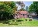 Spacious backyard with a lovely picnic table, fire pit and mature landscaping, ideal for outdoor activities at 3020 Washington Rd, East Point, GA 30344