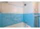 Bathroom featuring blue tile around the bathtub and shower with white walls at 3020 Washington Rd, East Point, GA 30344