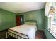 Cozy bedroom features hardwood floors, natural light and a ceiling fan for added comfort at 3020 Washington Rd, East Point, GA 30344