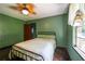 Cozy bedroom features hardwood floors, natural light and a ceiling fan for added comfort at 3020 Washington Rd, East Point, GA 30344