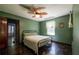 Cozy bedroom features hardwood floors, natural light and a ceiling fan for added comfort at 3020 Washington Rd, East Point, GA 30344