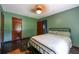 Cozy bedroom features hardwood floors, natural light and a ceiling fan for added comfort at 3020 Washington Rd, East Point, GA 30344