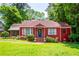 Charming red brick home with a well-manicured lawn and lush green trees at 3020 Washington Rd, East Point, GA 30344