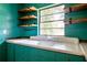 Bright kitchen features custom wood shelves, stainless fixtures, and abundant natural light at 3020 Washington Rd, East Point, GA 30344