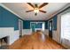 Inviting living room featuring hardwood floors, blue walls, and abundant natural light at 3020 Washington Rd, East Point, GA 30344