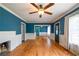 Inviting living room featuring hardwood floors, blue walls, and abundant natural light at 3020 Washington Rd, East Point, GA 30344