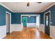 Elegant living room boasts hardwood floors, fresh paint, and a classic ceiling fan at 3020 Washington Rd, East Point, GA 30344