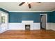 Cozy living room featuring hardwood floors, a brick fireplace, and natural light from windows at 3020 Washington Rd, East Point, GA 30344
