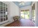 Porch with a porch swing, red tile floor, white brick walls, and a white ceiling at 3020 Washington Rd, East Point, GA 30344