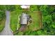 Aerial view of a home with a large, flat backyard featuring fresh landscaping, surrounded by dense, mature trees at 3262 Mitsy Forest Way, Marietta, GA 30068