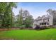 Expansive backyard with a wooden deck, screened porch, and beautiful landscaping at 3262 Mitsy Forest Way, Marietta, GA 30068