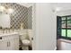 Stylish half bathroom with patterned wallpaper, modern fixtures, and a sleek vanity at 3262 Mitsy Forest Way, Marietta, GA 30068