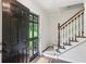 Inviting entryway featuring a staircase with wooden banister and an open front door at 3262 Mitsy Forest Way, Marietta, GA 30068