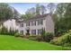 Well-maintained two-story home surrounded by mature trees, showcasing a classic design with a lovely front yard at 3262 Mitsy Forest Way, Marietta, GA 30068