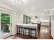 A bright kitchen featuring an island, breakfast bar and a doorway leading to an outdoor space at 3262 Mitsy Forest Way, Marietta, GA 30068