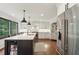 A kitchen island with a breakfast bar and stainless steel appliances at 3262 Mitsy Forest Way, Marietta, GA 30068