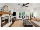 Cozy living room featuring a brick fireplace, wood mantel, and an adjacent sunroom at 3262 Mitsy Forest Way, Marietta, GA 30068