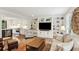 Open-concept living room with built-ins that connects to a modern kitchen with stainless steel appliances at 3262 Mitsy Forest Way, Marietta, GA 30068