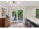 A bright kitchen features an island, breakfast bar, and a doorway leading to an outdoor deck at 3262 Mitsy Forest Way, Marietta, GA 30068