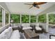 Screened porch features comfortable seating and views of the lush backyard at 3262 Mitsy Forest Way, Marietta, GA 30068