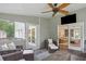 Screened porch boasts comfortable seating, a ceiling fan, and indoor/outdoor flow at 3262 Mitsy Forest Way, Marietta, GA 30068