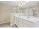 Bathroom with double sink vanity, white cabinetry, and walk-in shower at 5159 Wellsley Bnd, Alpharetta, GA 30005