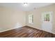 Bedroom features a ceiling light, wood floors, and a door to the backyard at 5159 Wellsley Bnd, Alpharetta, GA 30005